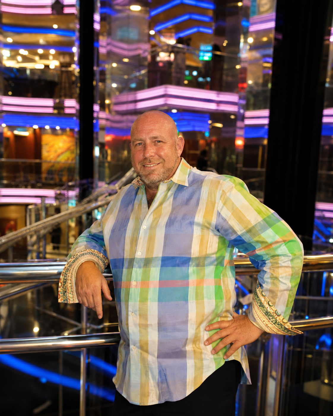 Ron Devine smiling in a colorful checked shirt
